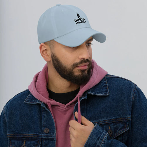 Bearded male model wearing Respect Existence Silver Trucker Hat and olive jacket