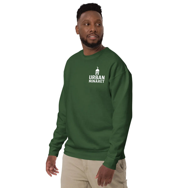 A man wearing an Urban Minaret premium unisex forest green sweatshirt with a white brand logo on the left chest.
